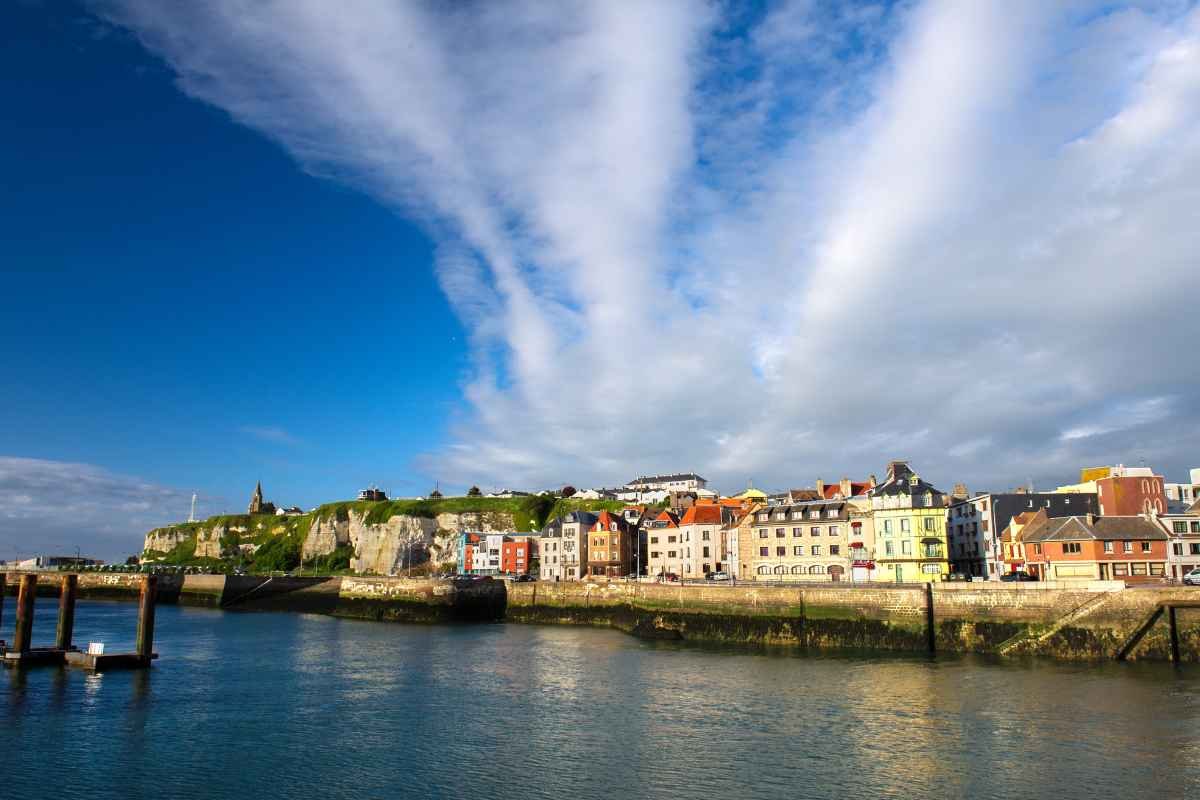Dieppe waterfront buildings and chalk cliffs seen across the harbour water